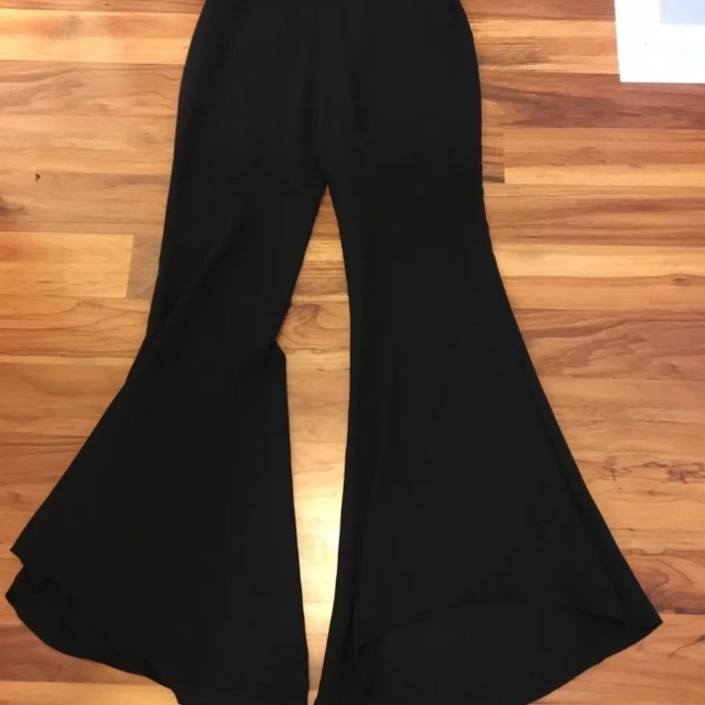 Lush black palazzo dress pants with a hi low hem.
